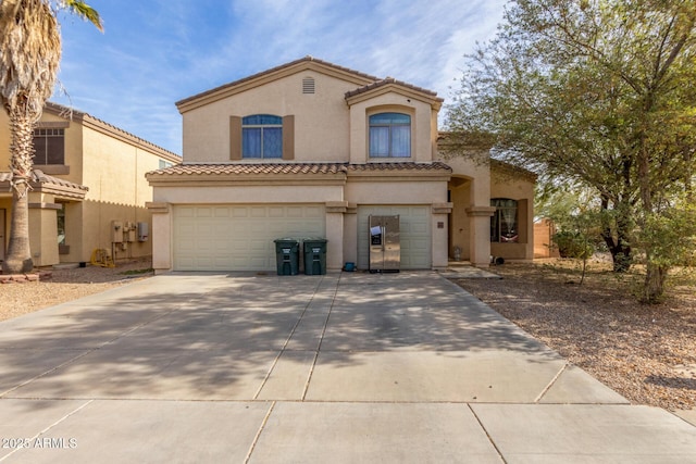 mediterranean / spanish-style home featuring a garage