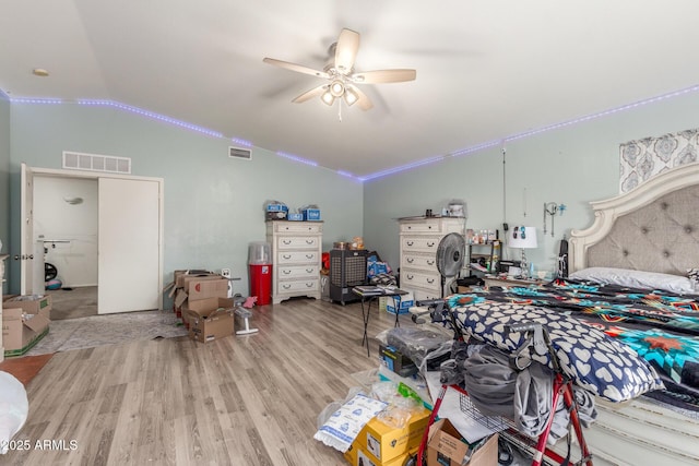 bedroom featuring ceiling fan, vaulted ceiling, and light hardwood / wood-style flooring