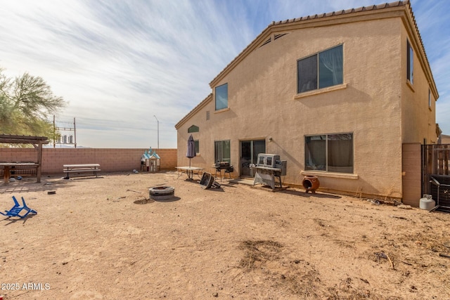 back of house featuring a fire pit