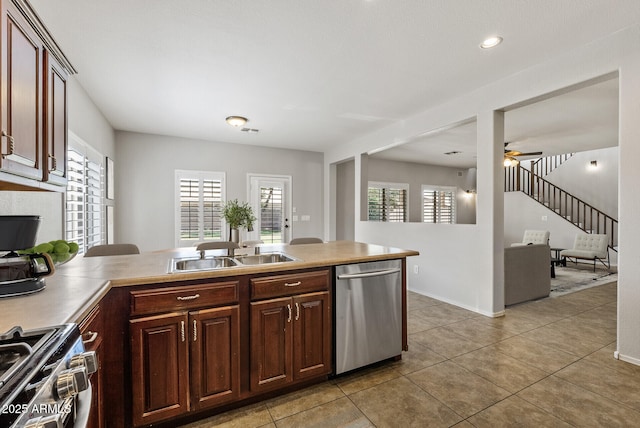 1125 E San Carlos Way, Chandler, AZ 85249 - kitchen with stainless steel appliances, a ceiling fan, light tile patterned floors, a peninsula, and light countertops