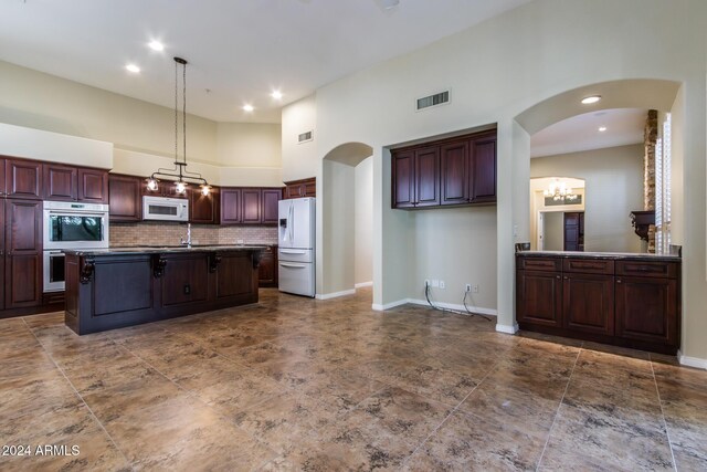 view of patio / terrace with ceiling fan and a fire pit