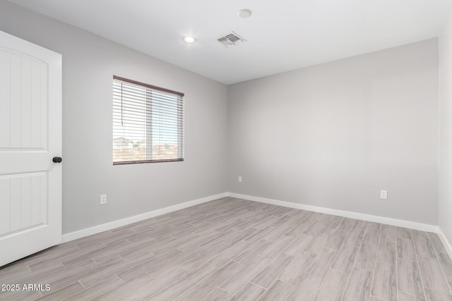 unfurnished room with light hardwood / wood-style flooring