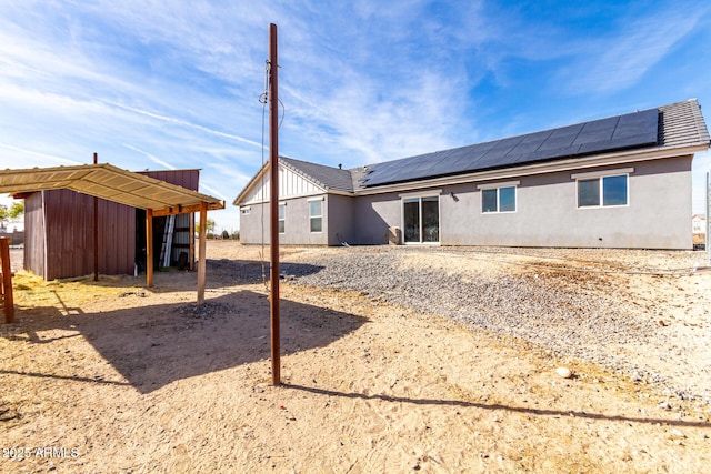 rear view of house with solar panels