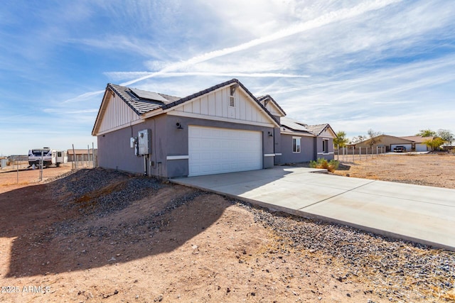 view of front of house featuring a garage and solar panels