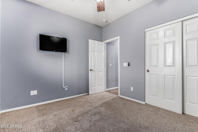 unfurnished bedroom featuring a ceiling fan, a closet, carpet flooring, and baseboards