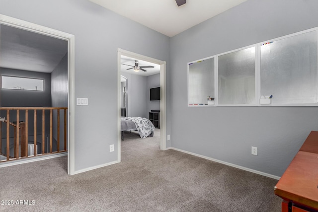 interior space with carpet and baseboards