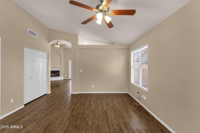 unfurnished room with dark wood-style flooring, a ceiling fan, visible vents, and lofted ceiling