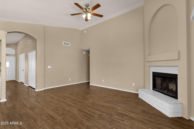 unfurnished living room featuring high vaulted ceiling, a ceiling fan, dark wood finished floors, and visible vents