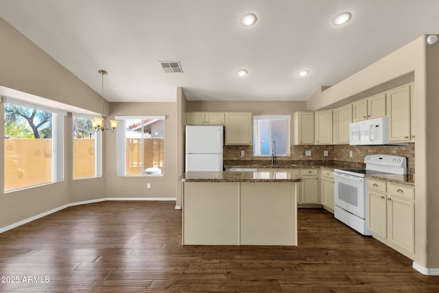 kitchen with decorative backsplash, visible vents, a sink, an inviting chandelier, and white appliances