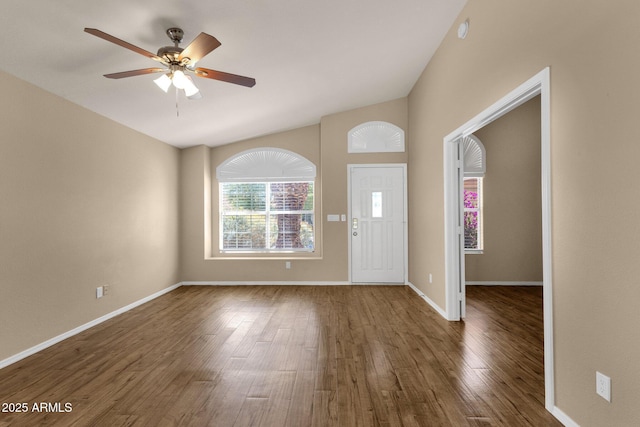 foyer featuring baseboards, a ceiling fan, vaulted ceiling, and wood finished floors