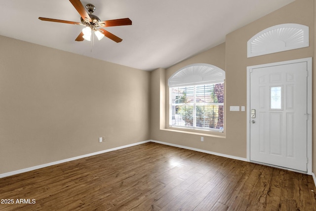 entryway featuring a ceiling fan, baseboards, wood finished floors, and lofted ceiling