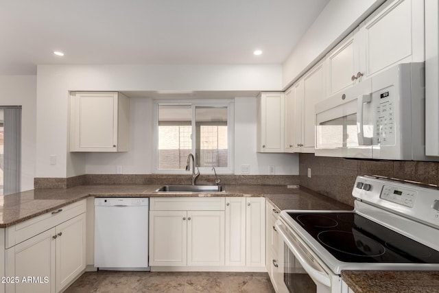 kitchen with recessed lighting, white cabinetry, a sink, white appliances, and a peninsula