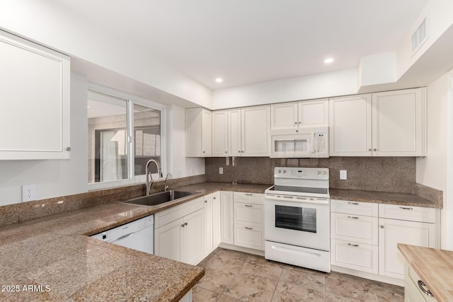 kitchen with white appliances, white cabinetry, a sink, and visible vents