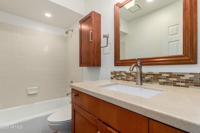 full bath featuring tasteful backsplash, toilet,  shower combination, vanity, and recessed lighting