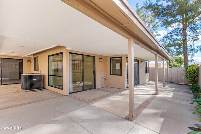 view of patio / terrace with fence and cooling unit