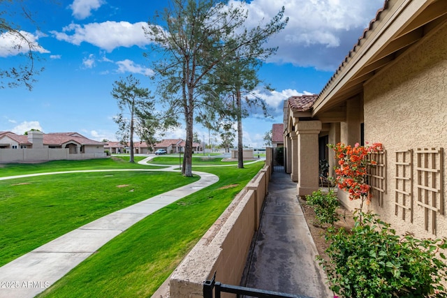 exterior space featuring a yard, fence, and a residential view