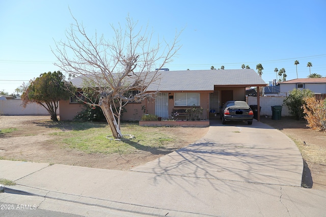 ranch-style house featuring a carport