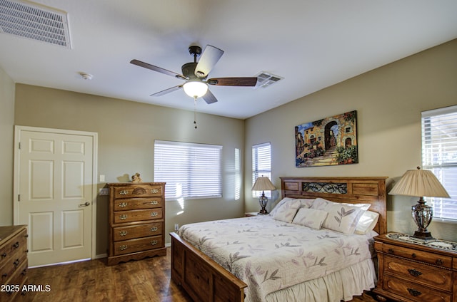 bedroom with ceiling fan and dark hardwood / wood-style floors