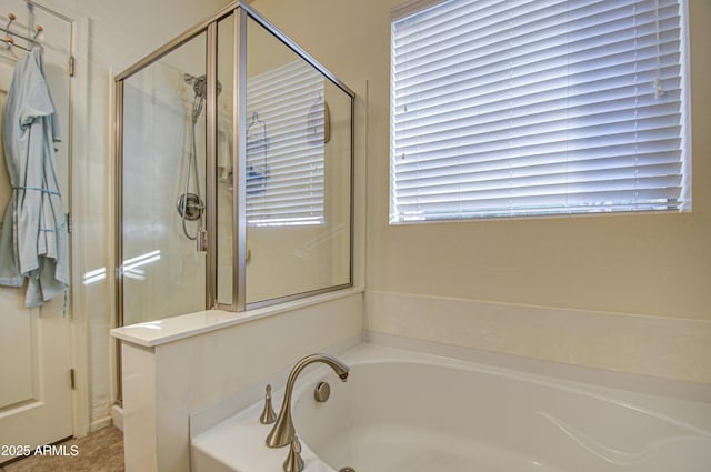 bathroom featuring independent shower and bath