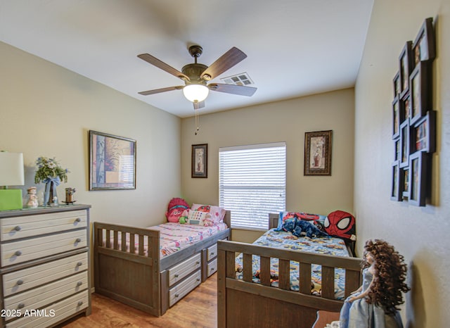 bedroom featuring ceiling fan and light hardwood / wood-style floors