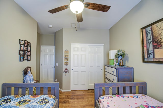 bedroom featuring ceiling fan, wood-type flooring, and a closet