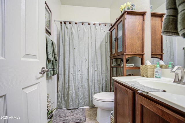 bathroom with walk in shower, vanity, and toilet