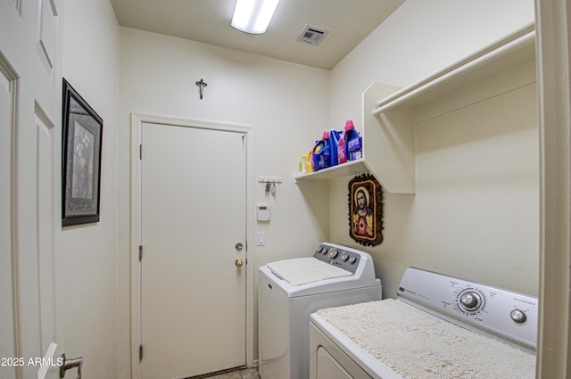 laundry room featuring washing machine and clothes dryer