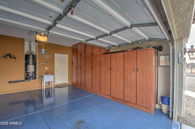 garage featuring a garage door opener, gas water heater, and sink