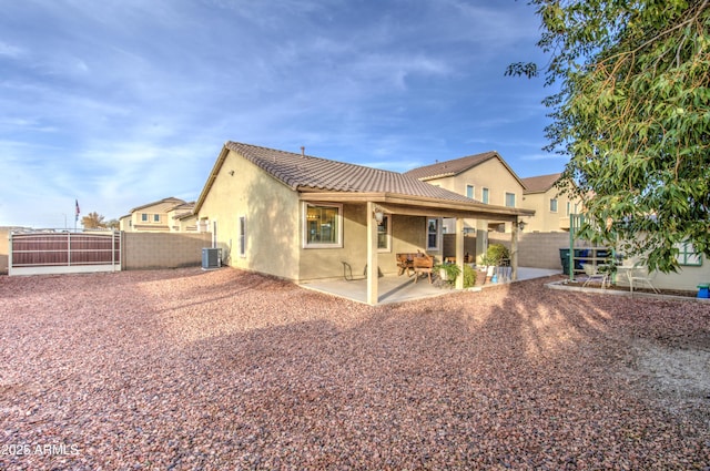 back of property featuring a patio and central AC