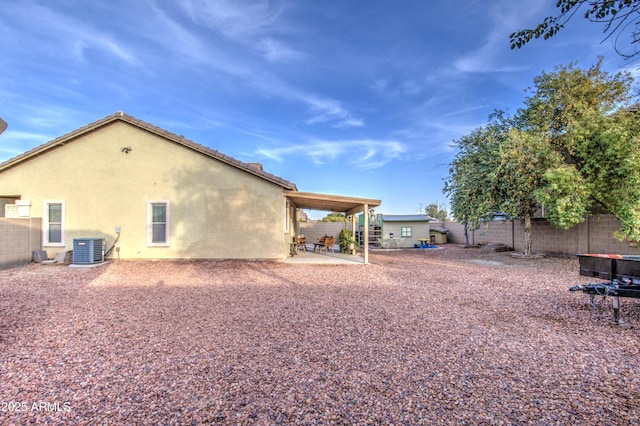 back of house with central AC unit and a patio area