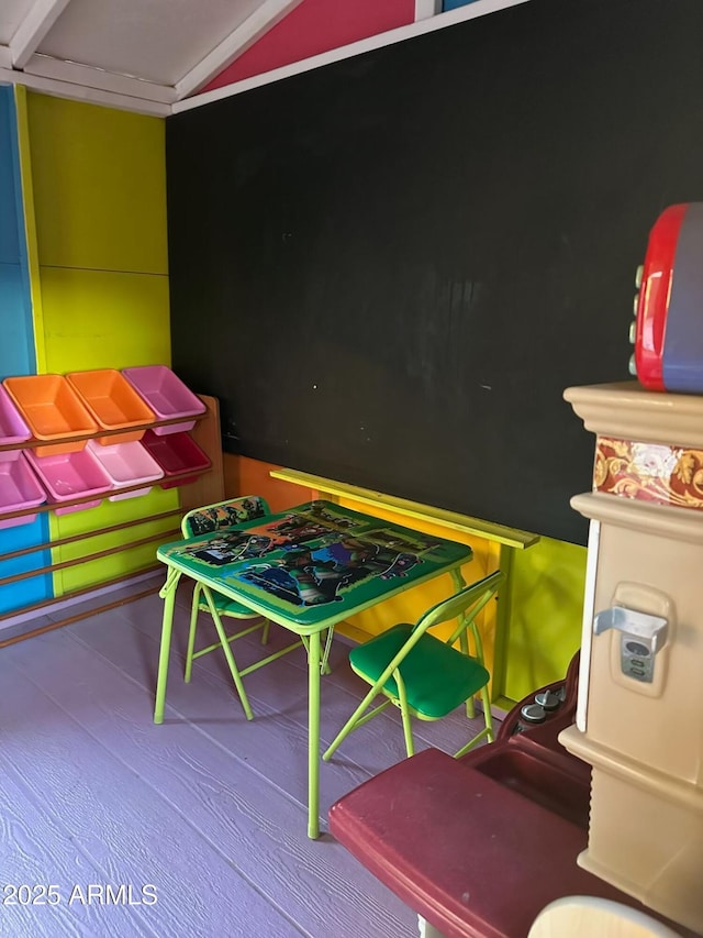 game room with vaulted ceiling