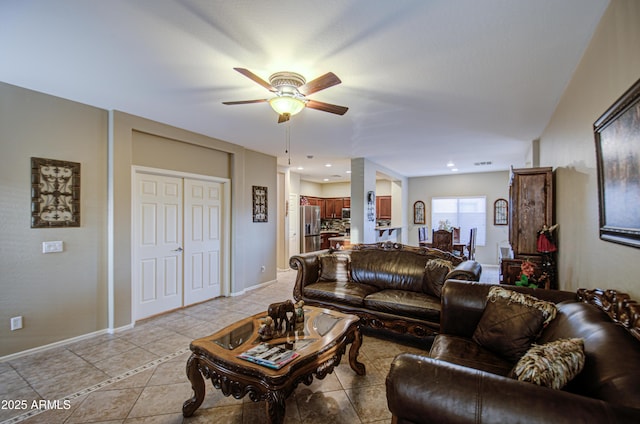 tiled living room with ceiling fan