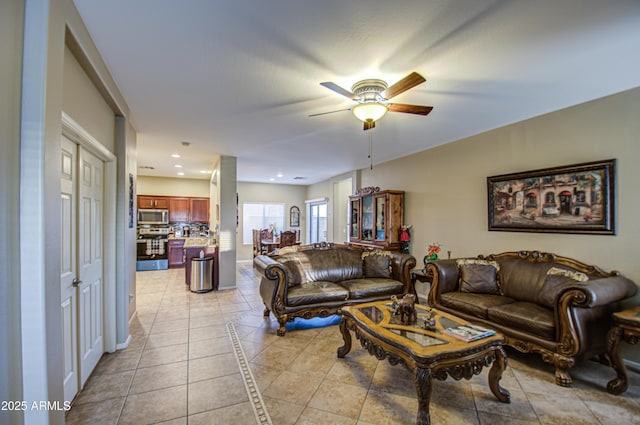 living room featuring ceiling fan and light tile patterned flooring