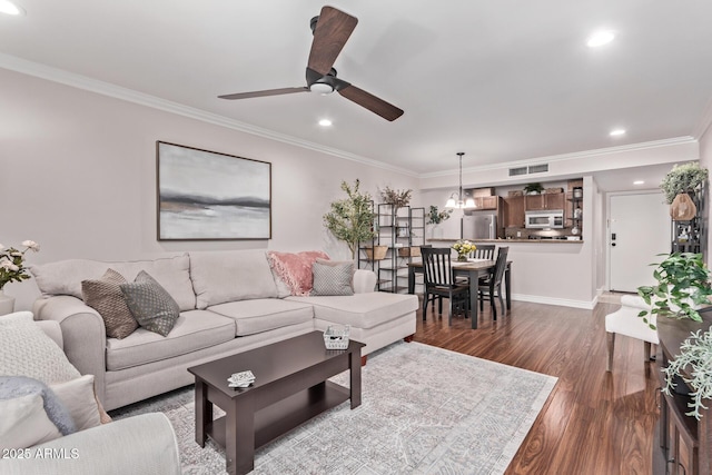 living area featuring crown molding, ceiling fan, recessed lighting, dark wood-type flooring, and visible vents