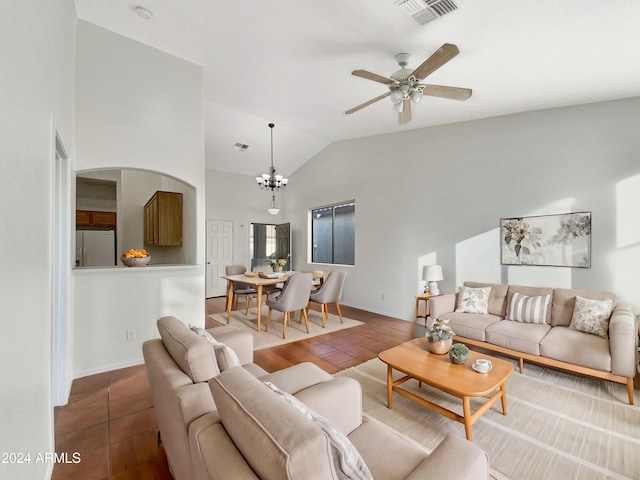 living room with tile patterned flooring, ceiling fan with notable chandelier, and high vaulted ceiling