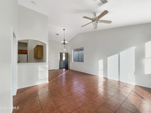 unfurnished living room featuring ceiling fan with notable chandelier, high vaulted ceiling, and dark tile patterned floors