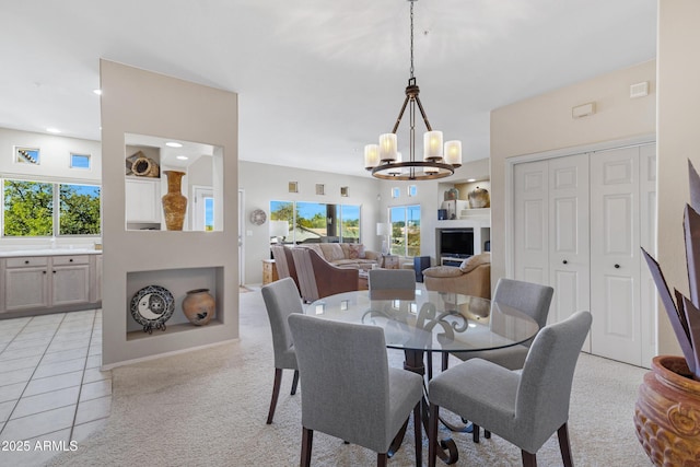 dining area featuring light tile patterned floors, a notable chandelier, recessed lighting, and light carpet