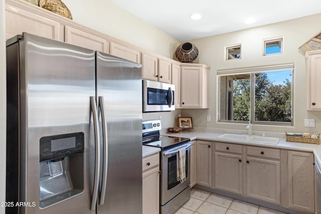 kitchen with light countertops, recessed lighting, light tile patterned flooring, stainless steel appliances, and a sink