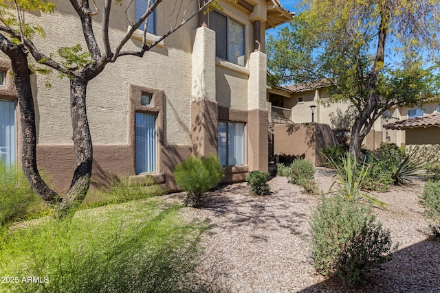 view of side of home with stucco siding