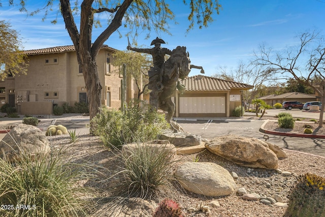 exterior space featuring stucco siding and a tiled roof