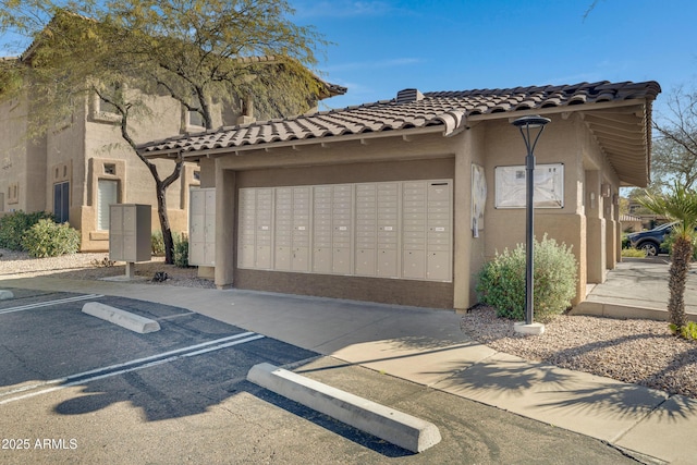 exterior space featuring mail area and uncovered parking