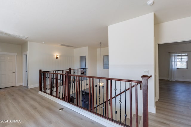 hall with light hardwood / wood-style floors