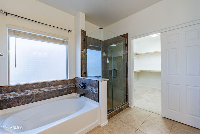 bathroom with plenty of natural light, tile patterned floors, and separate shower and tub