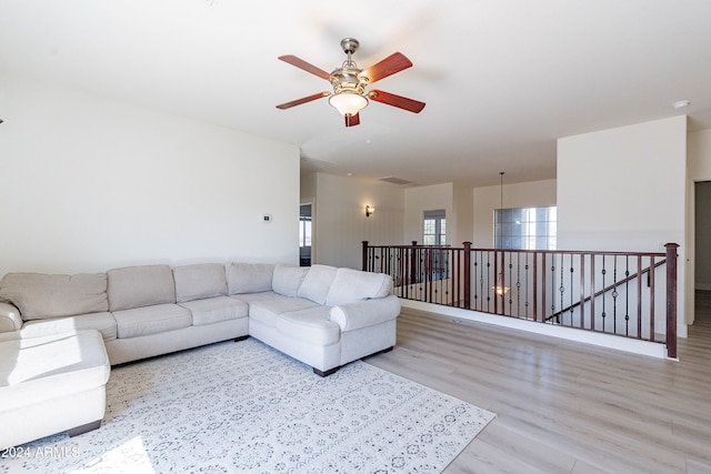 living room featuring light wood-type flooring and ceiling fan