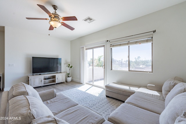 living room with light hardwood / wood-style floors and ceiling fan