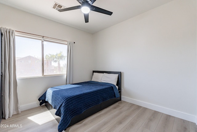 bedroom with light wood-type flooring and ceiling fan