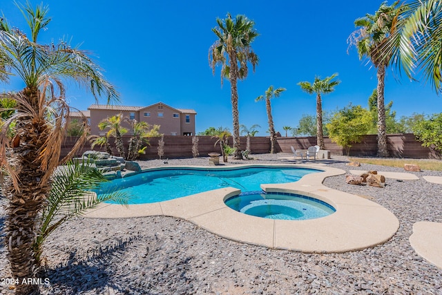 view of pool with a patio and an in ground hot tub