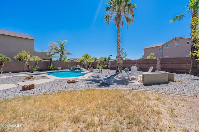 view of pool with a patio and an outdoor fire pit