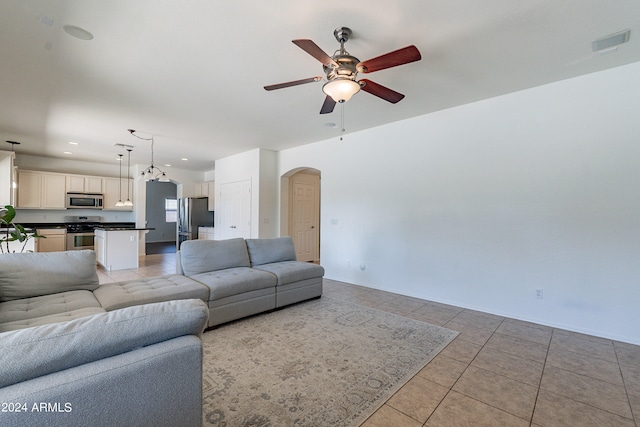 tiled living room with ceiling fan