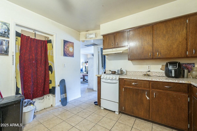 kitchen with white electric range oven, light tile patterned floors, visible vents, light countertops, and under cabinet range hood